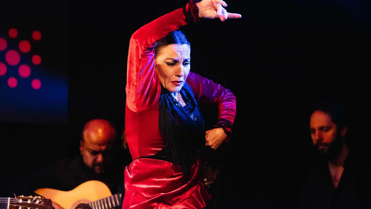 Flamenco dancer performing in a palace patio after tapas on an evening Seville food tour with a flamenco show